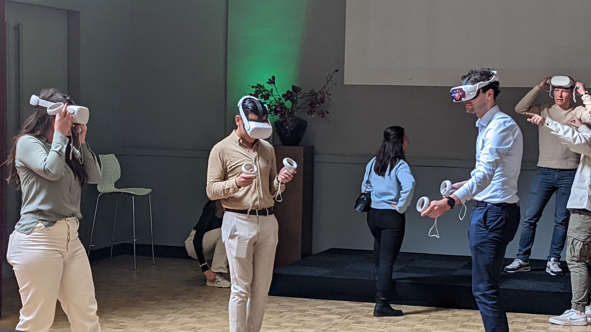 Group of colleagues wearing VR headsets together during a shared group activity.